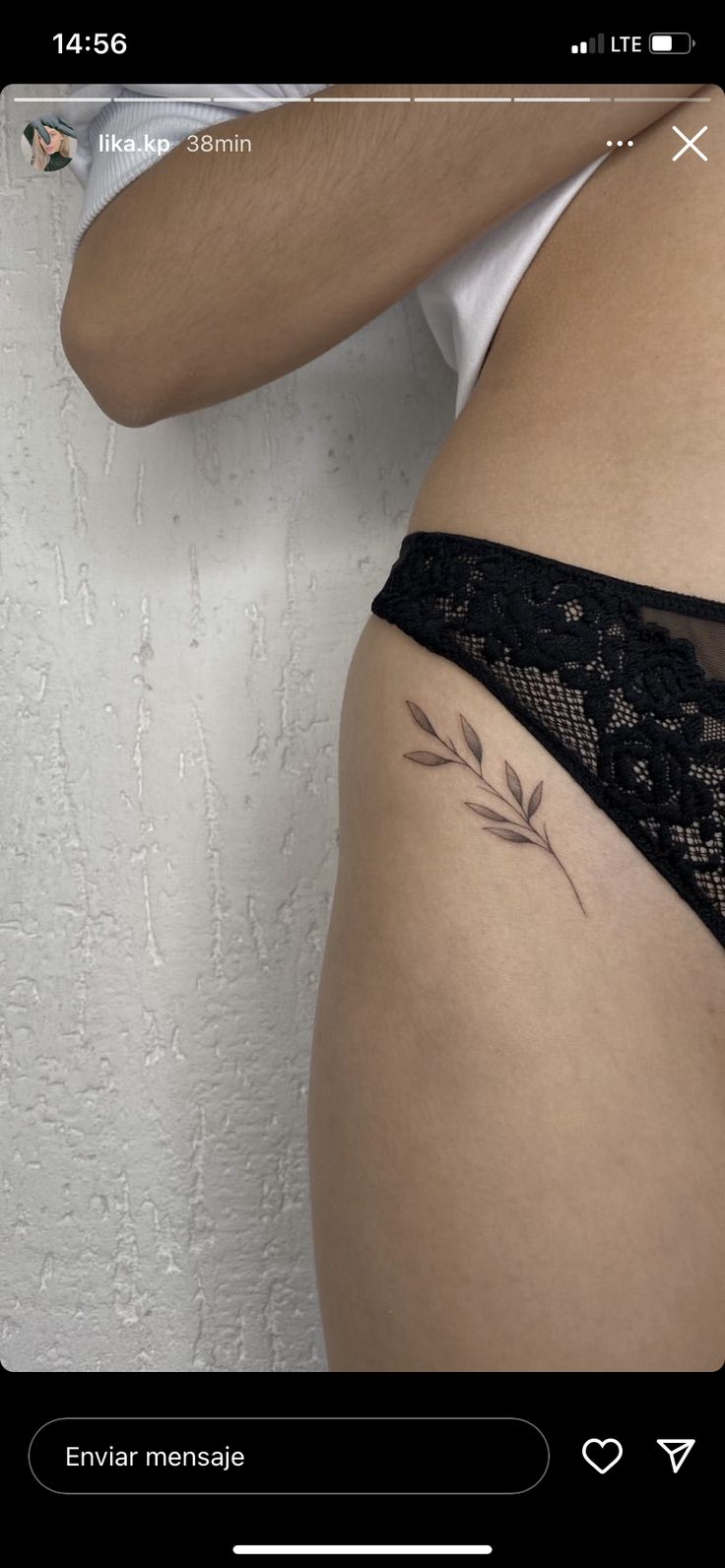 a woman's stomach with a tattoo on the side and an arrow in the middle