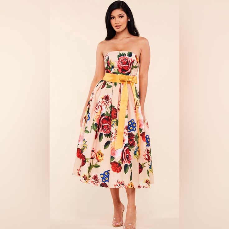 Rose Garden Print Peach Strapless Midi Dress Features A Circle Skirt And Contrast Yellow Ribbon Waist Band Adorned With A Bow. Exposed Metal Zipper Back Petticoat Lining Textured Fabric Multicolor Midi Strapless Dress For Spring, Strapless Floral Print Midi Dress For Garden Party, Strapless Midi Dress With Floral Print For Brunch, Sleeveless Rose Print Dress For Garden Party, Strapless Floral Print Midi Dress For Brunch, Strapless Floral Print Dress For Summer Cocktail, Yellow Floral Print Midi Dress For Cocktail, Sleeveless Rose Print Dress For Day Out, Yellow Strapless Dress For Garden Party