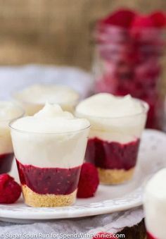 small desserts with raspberry sauce and whipped cream are on a white plate