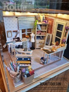 a doll house with furniture and accessories in it's display case on the floor