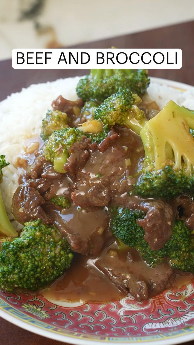 beef and broccoli served over white rice on a colorful plate with floral designs