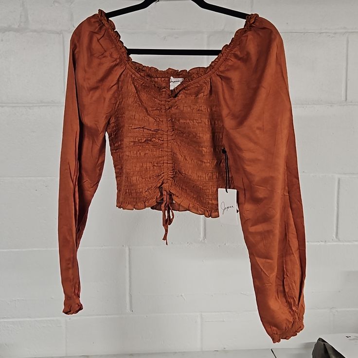 Gorgeous Soft Top. Nwt Never Worn. Beautiful Rusty Orange Color. Smocked And Cropped With Ties. Ruffled Neckline And Puffy Sleeves. Size Large But Looks Small, Probably Could Work For Small/Medium. Smoke-Free Home Long Sleeve Smocked Top For Fall Day Out, Fall Peasant Top With Smocked Back For Day Out, Fall Smocked Top For Day Out, Casual Fall Smocked Top With Smocked Bodice, Brown Smocked Back Top For Spring, Casual Smock Brown Tops, Casual Smocked Top With Smocked Bodice For Fall, Fitted Smock Peasant Top For Fall, Casual Brown Smock Tops