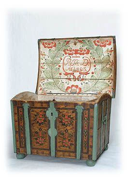 an old wooden trunk sitting on top of a white floor