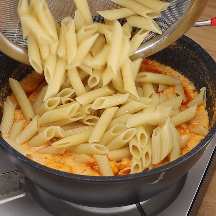 pasta being cooked in a skillet on the stove