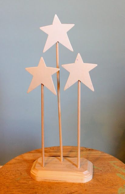 three wooden stars on top of each other