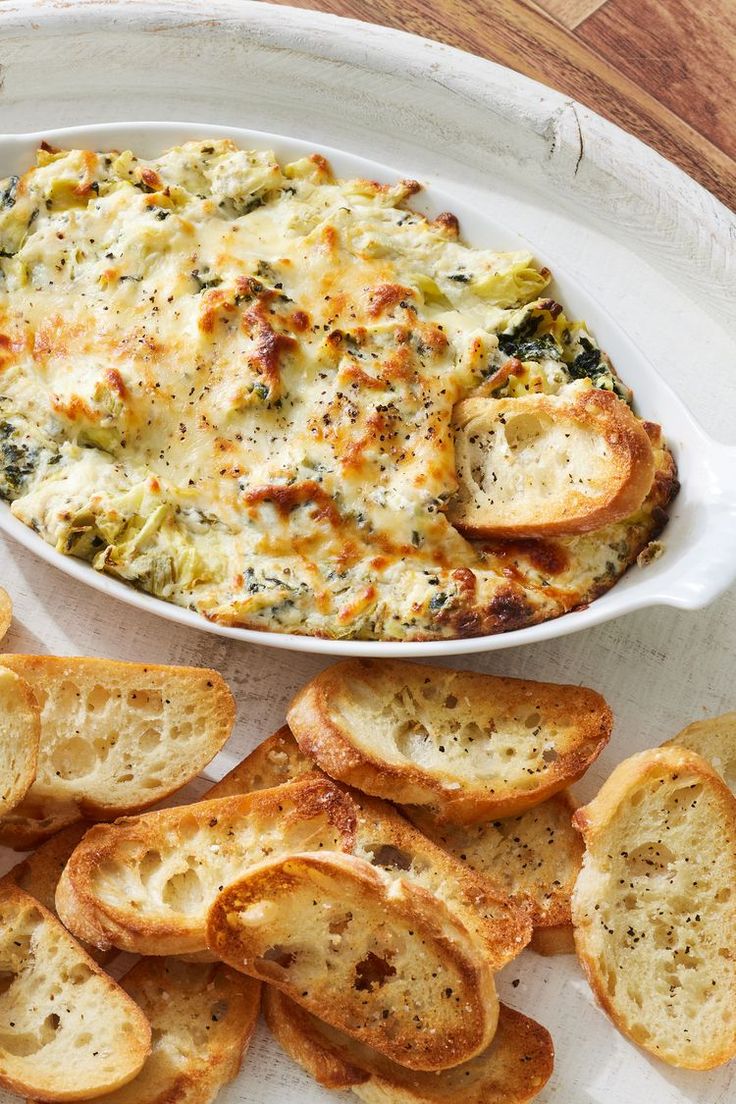 a white plate topped with bread slices and a casserole dish filled with broccoli