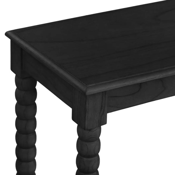 a black wooden table with turned legs