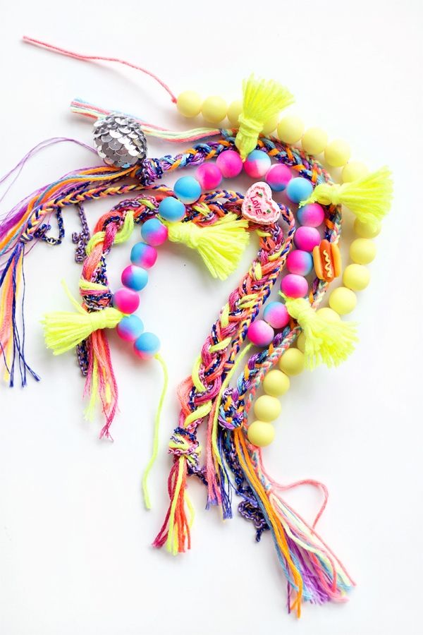 colorful bracelets with tassels and beads on white background