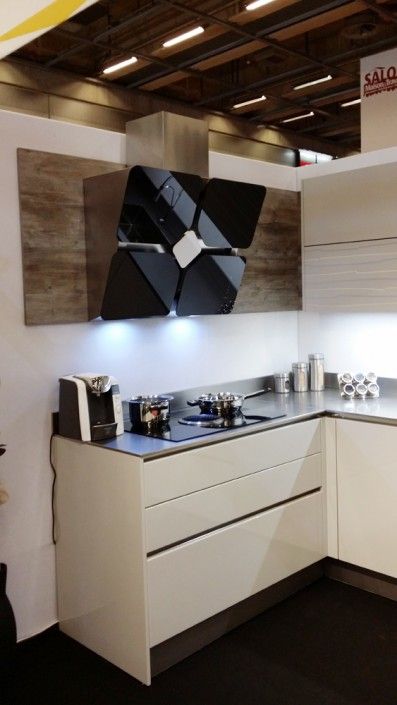 a modern kitchen with white cabinets and black counter tops is displayed at an exhibition or show