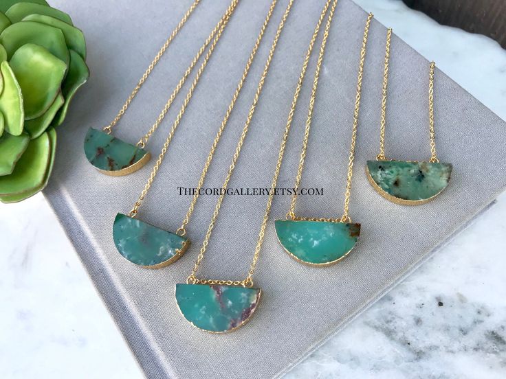 **Each piece in my shop, I personally create and photograph. (All photos are property of The Cord Gallery LLC) Thank you for supporting my small business. These stunning and natural necklaces are made from Green Chrysoprase Slices that have been cut into half moon shapes. Each is trimmed in gold electroplating and hangs on your choice of 14k Gold Plated or 14k Gold Filled chain in the length of your choosing. The stones are double sided so they look pretty no matter how they lay. Choose how you' Nature-inspired Chrysoprase Necklaces, Nature-inspired Chrysoprase Necklaces As Gift, Nature-inspired Chrysoprase Necklace As Gift, One-of-a-kind Green Chrysoprase Necklace, Untreated Jade Jewelry Gift, Untreated Jade Jewelry For Gift, Untreated Green Pendant Necklace, Chrysoprase Round Pendant Necklace As Gift, Chrysoprase Round Pendant Necklace For Gift