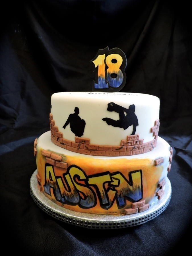 a three tiered cake with graffiti on it