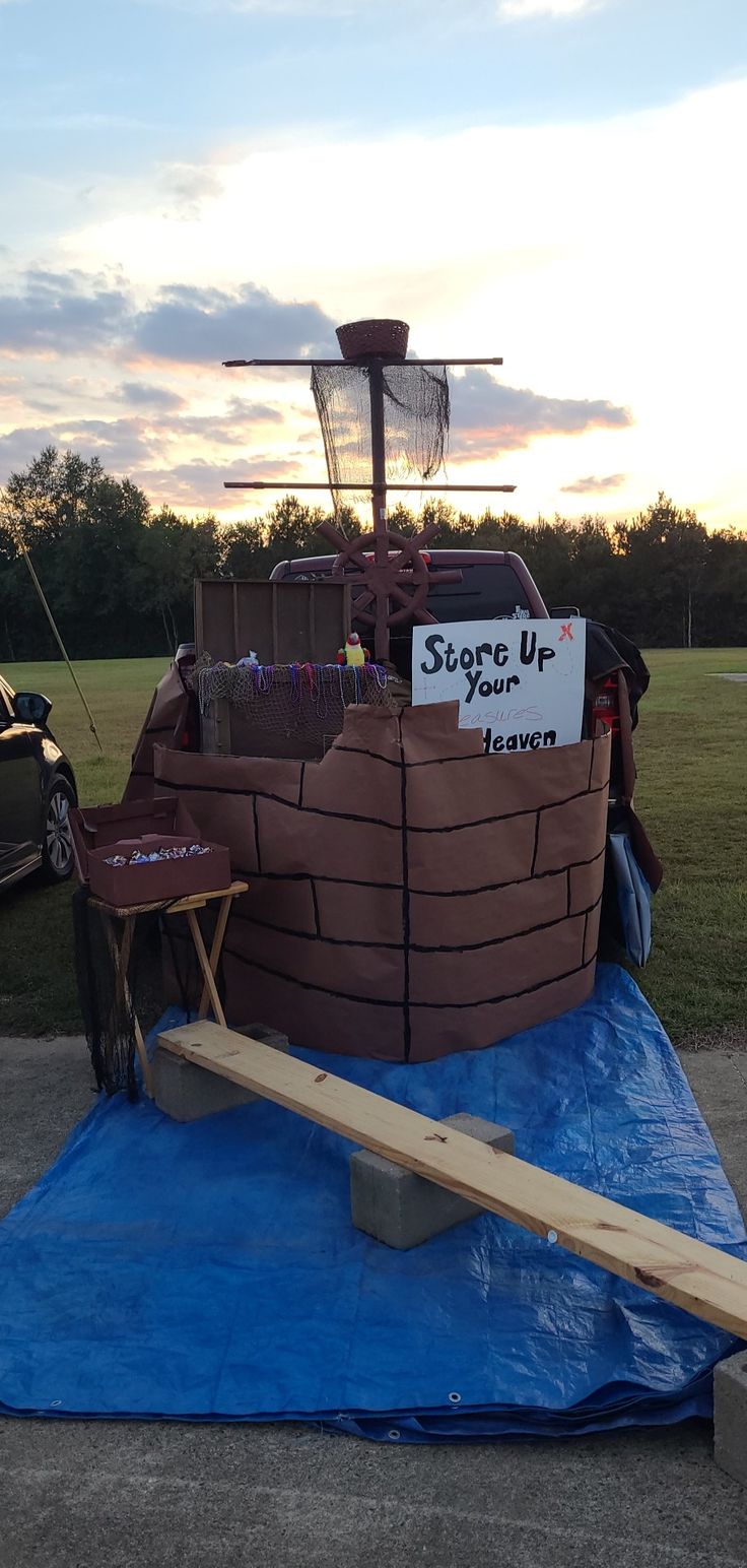 a boat made out of cardboard sitting on top of a tarp