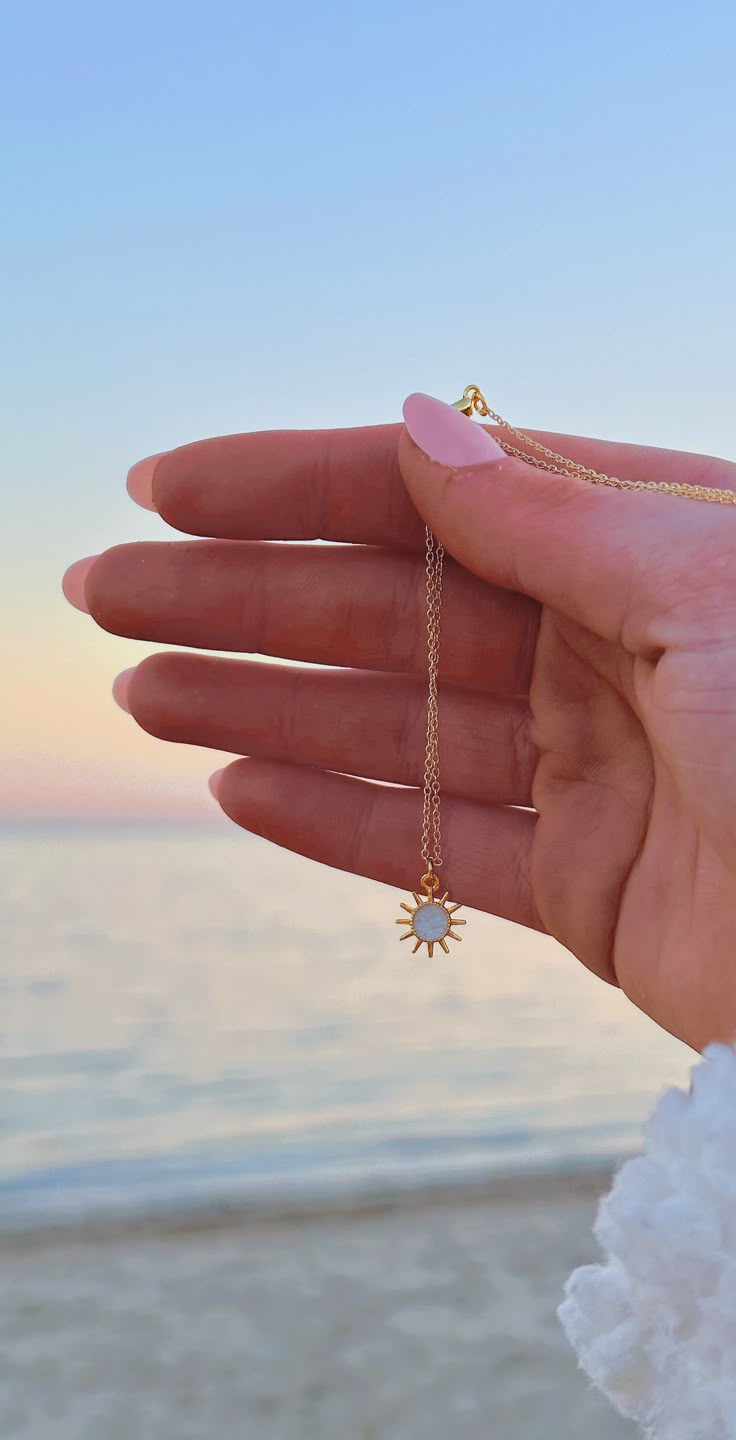 The necklace you need when you're craving that summer sun. This dainty charm necklace features a golden sun charm with pearly white enamel in the center that sparkles in the sunlight. It's the perfect combination of sparkling and beachy, just like your favorite summer days. Wear alone as an everyday piece or layer with our ocean-inspired necklaces to bring the beach home with you. Necklace features: 14k gold plated or 14k gold filled chain 16 inches in length with 2-inch extender chain Dainty 24 Ocean Jewelry Aesthetic, Preppy Tropical, Beachy Necklace, Coastal Jewelry, Surf Jewelry, Beachy Jewelry, Preppy Jewelry, Sun Charm, Golden Sun