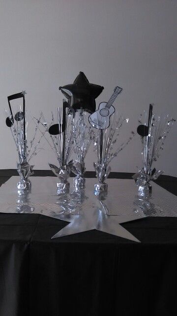 a table topped with silver and black decorations