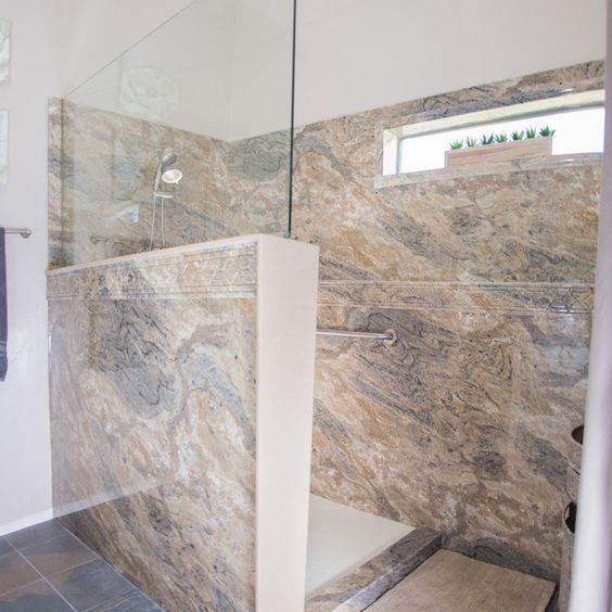 a walk in shower sitting inside of a bathroom