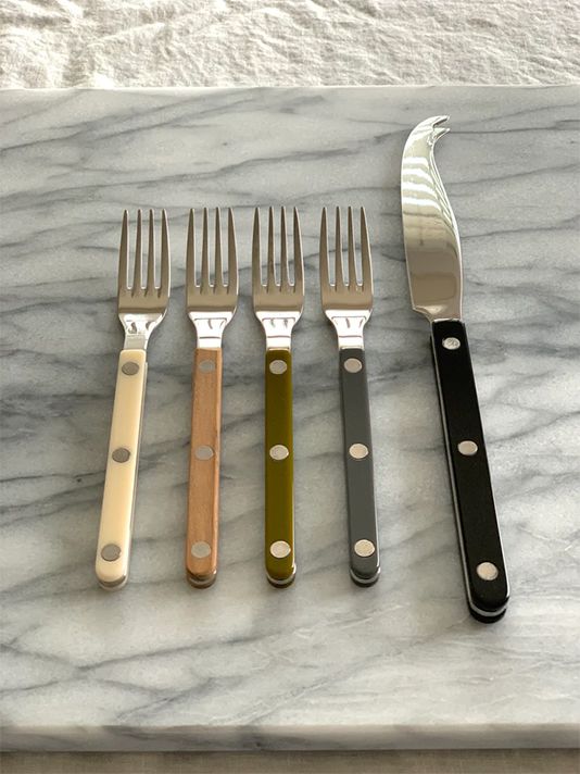 five different types of knives and forks on a marble surface