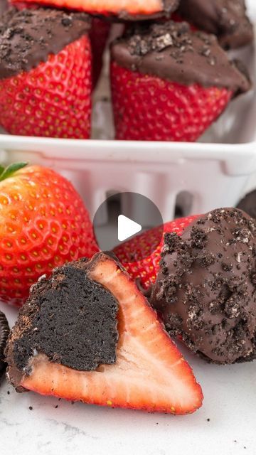 two white bowls filled with chocolate covered strawberries and one has a bite taken out of it