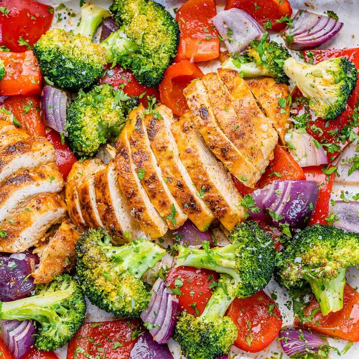 chicken, broccoli and red onion salad on a white platter