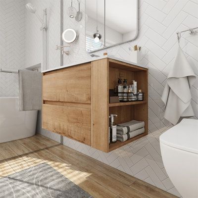 a bathroom with a sink, mirror and toilet in it's corner area next to a bathtub