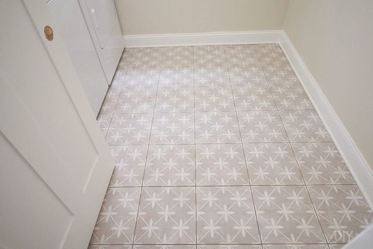 a bathroom with a white door and tiled floor