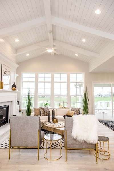 a living room filled with furniture and a fire place in the middle of a room