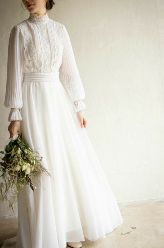 a woman in a white dress holding a bouquet