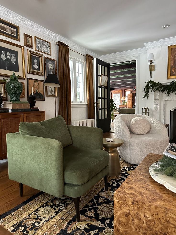 a living room filled with furniture and pictures on the wall