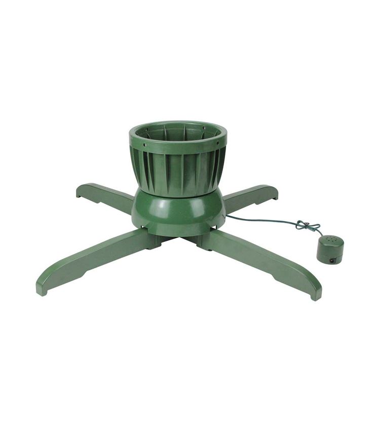 a green plastic flower pot sitting on top of a metal stand with an electric cord attached to it