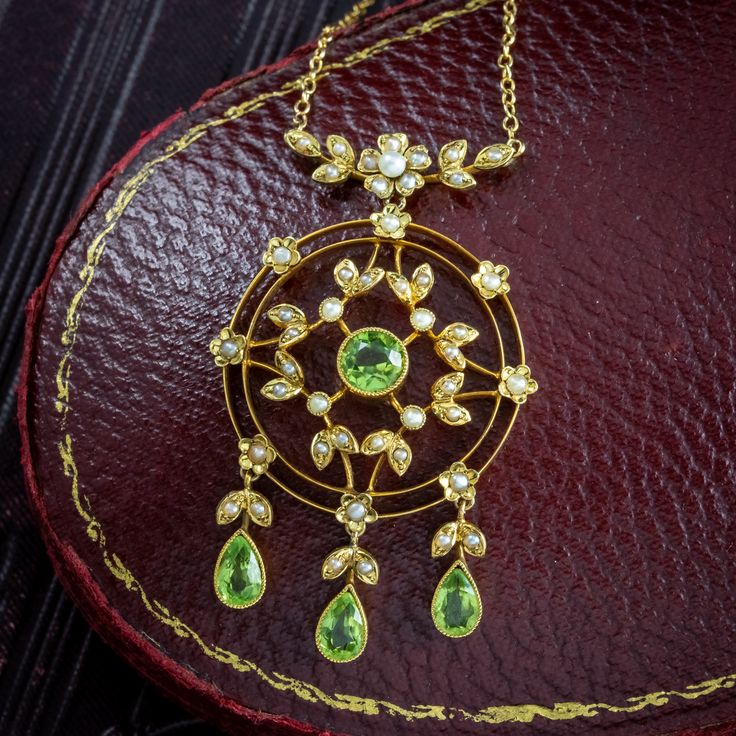 New in! A gorgeous antique Edwardian peridot pearl lavaliere pendant necklace fashioned in 15ct gold. The fabulous, open-work pendant is decorated with flowers and leaves and set with bright seed pearls and four natural green peridots, one in the centre, and three more dangling from droppers at the bottom. The pendant is in excellent condition and the green, white and gold hues evoke the beauty of summertime, or a meadow of green grass and white daises. It dates to the early 1900s and hangs... Edwardian Engagement Ring, Peridot Necklace, Inner Light, Green Peridot, Seed Pearl, August Birth Stone, Memento Mori, Green Grass, Early 1900s