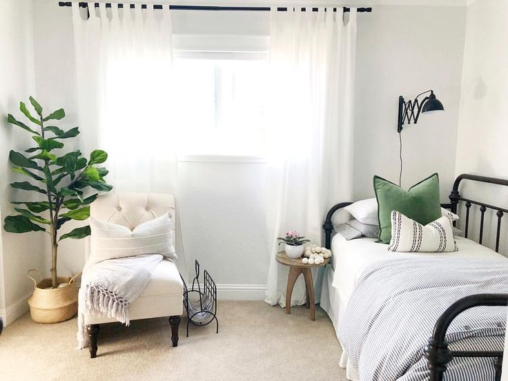 a bedroom with white walls and green accents