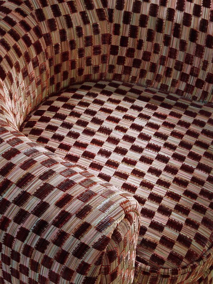 an upholstered couch with red and white checkered fabric