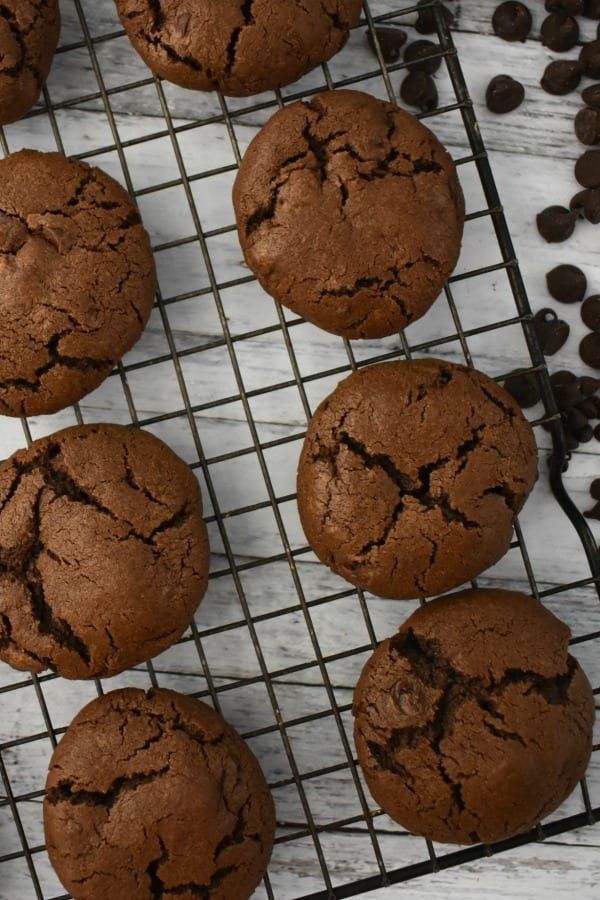 chocolate cookies cooling on a wire rack next to coffee beans