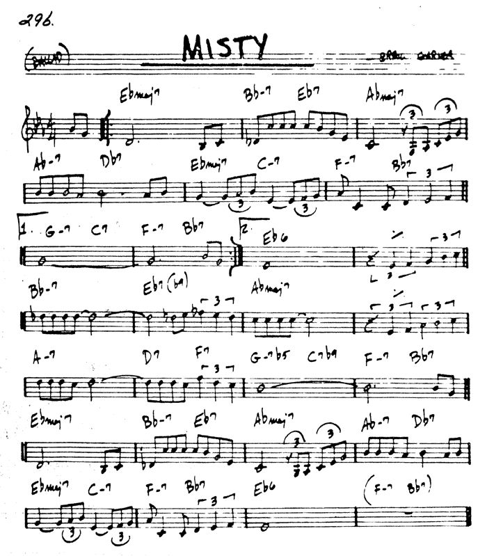 sheet music with the words misty written in black ink on top of it and an image of