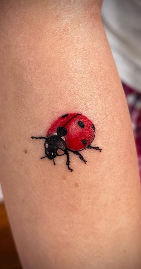 a ladybug tattoo on the thigh