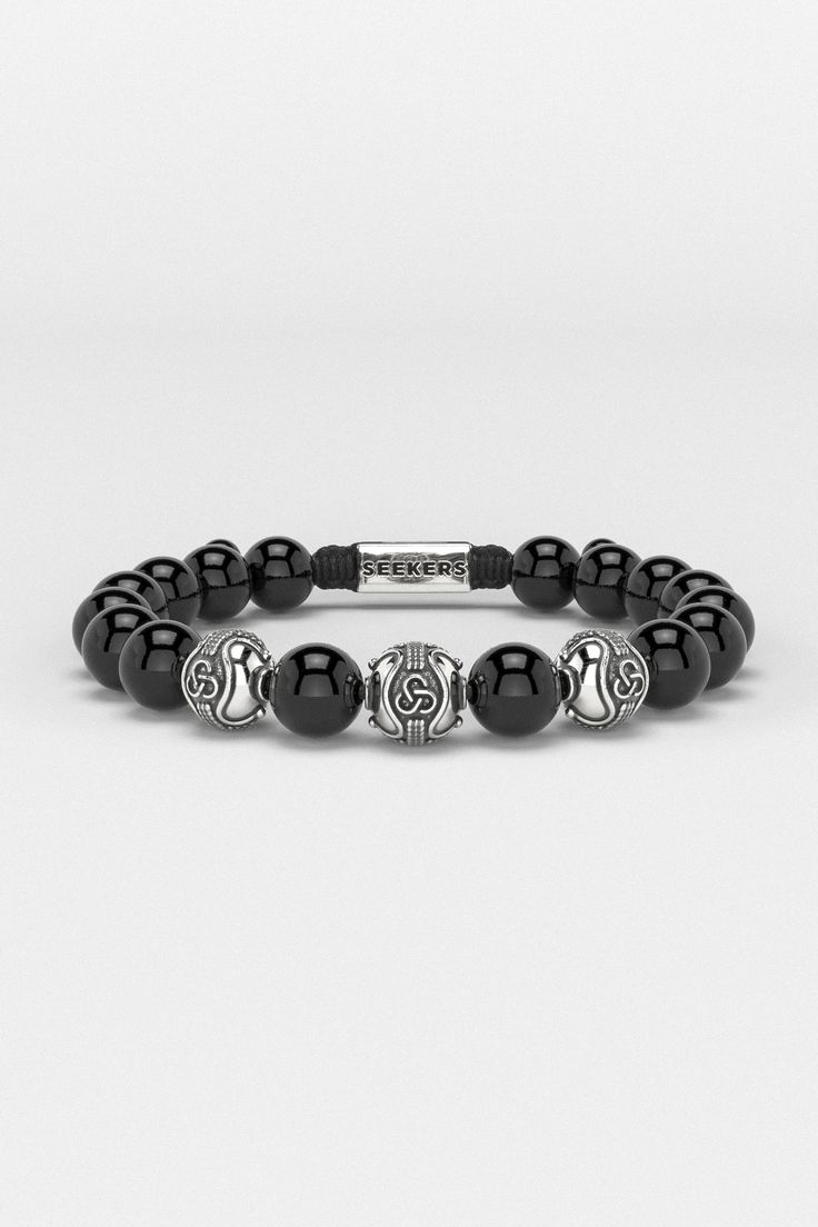 Introducing the Premium Bracelet, embodying the eternal quest for personal growth and self-realization. Its design, inspired by an infinite symbol in three dimensions, represents the mind, body, and spirit's interconnected journey. This piece symbolizes the relentless pursuit of one's true purpose, reminding us that in every mindful step lies the essence of life and the path to becoming the person we aspire to be. All our stones are chosen by hand to satisfy AAA quality standards. They are natural stones and their size and color can vary slightly. Stone: AAA Grade 10mm (Choose your favorite from available ones) Metal: 925 Sterling Silver / 24k Gold Plated / Rhodium over 925 Sterling Silver 100% Handcrafted Package: High quality velvet pouches Modern Black Bracelet With 8mm Beads, Modern Black Bracelets With 8mm Beads, Modern Black Jewelry With 8mm Beads, Elegant Obsidian Beads Jewelry 8mm, Luxury Adjustable Black Wristband, Modern Silver Bracelets With Gemstone Beads, Elegant Silver Obsidian Beaded Bracelets, Modern Gemstone Beads Bracelets, Luxury Black Jewelry With 8mm Beads