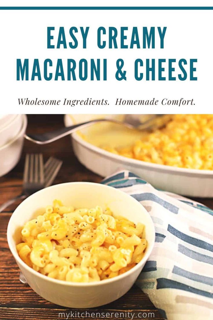 two bowls filled with macaroni and cheese on top of a wooden table next to a