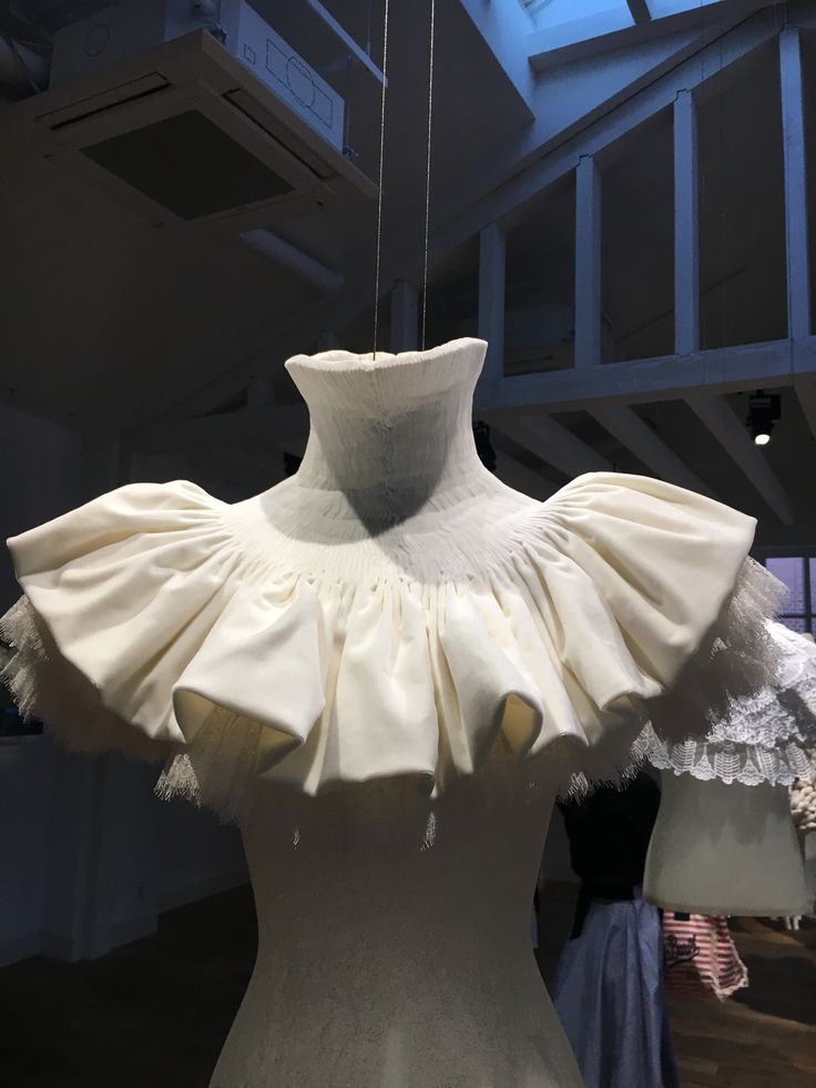 a white dress on display in a museum