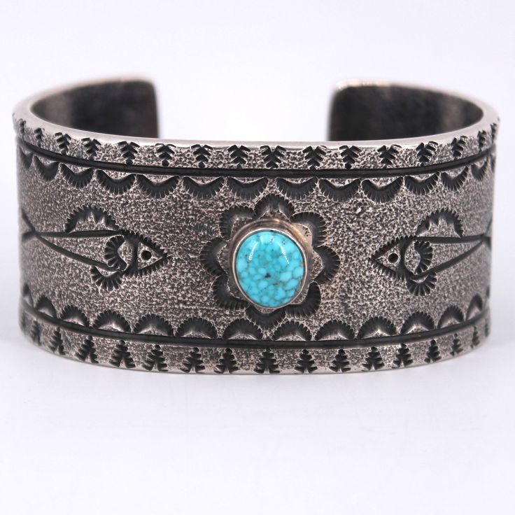 Sterling silver cuff sandcasted to give the surface a gorgeous texture, featuring a beautiful piece of turquoise and engravings of fish along the edges of the stone. Artisan-made and a show-stopping piece! Luxury Southwestern Kingman Turquoise Cuff Bracelet, Fish Motif, Turquoise Cuff, Sterling Silver Cuff, The Stone, Silver Cuff, Turquoise Bracelet, Cuff Bracelets, Cuff