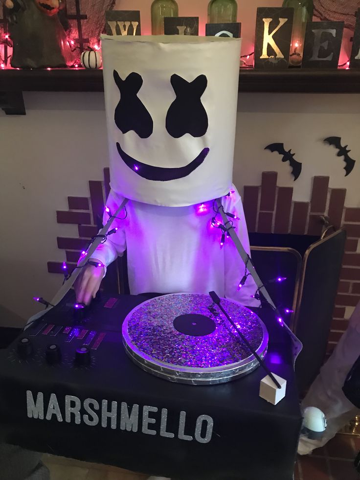 a costume made to look like marshmallow is playing the dj's turntable