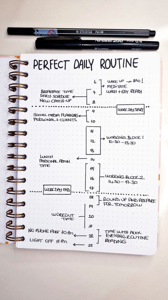 a notebook with a daily routine on it and a pen resting on the page next to it