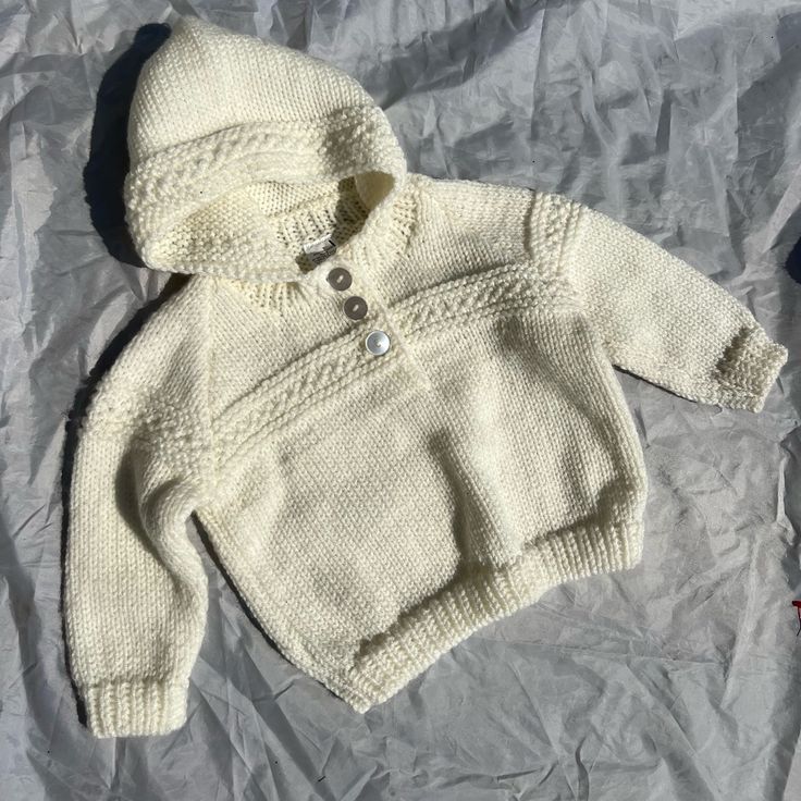 Cream Knit Sweater Fits 12-24 Months In Almost Brand New Condition Cozy Winter Sweater For Playtime, Cozy Knitted Sweater For Playtime, Cozy Knitted Sweater For Casual Wear, White Warm Knit Sweater, Warm White Knit Sweater, White Hooded Knitted Sweater, White Knitted Hooded Sweater, Cozy White Knitted Hoodie, White Knitted Tops For Cold Weather