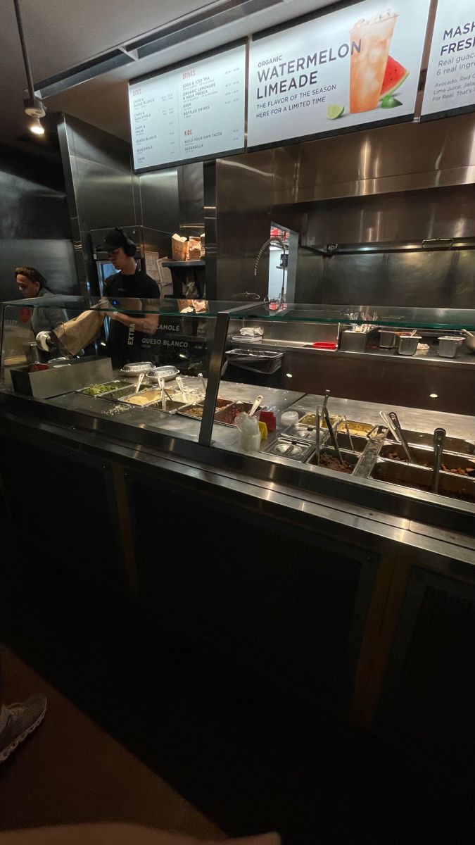 people working behind the counter at a restaurant