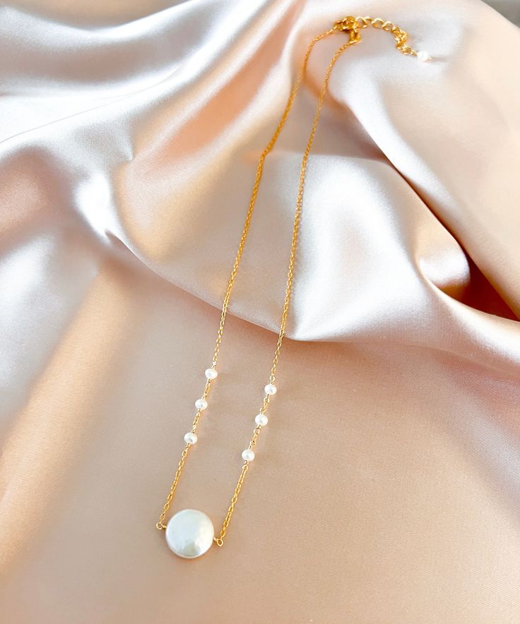 Lustrous round freshwater coin pearl hung on a delicate 14k gold-plated chain.Adjustable length "16-18".Handmade in the USA. Coin Pearl Jewelry, Elegant 14k Gold Filled Coin Necklace, Adjustable Gold Pearl Necklace, Delicate Pearl Necklace With Adjustable Chain, Gold Coin Necklace With Pearl Chain, Delicate Round Pearl Necklace With Adjustable Chain, 14k Gold-filled Pearl Pendant Necklace, Elegant Adjustable Disc Necklace, Pearl Chain Coin Necklace