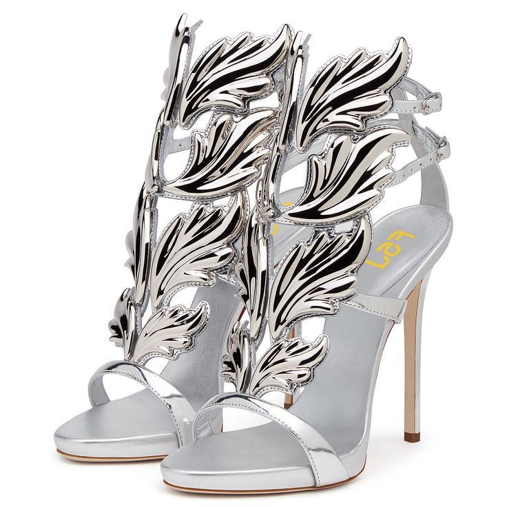 Elevate your evening look with these metallic silver strappy-heeled sandals. Featuring an open-toe and adjustable buckle strap design, these shoes add a touch of glamour and sophistication to any outfit. Color: Silver Material: Metallic finish Heel type: Stiletto Heel Heel height: 4.72" / 120 mm approx Product measurements were taken using size 8. Please note that measurements may vary by size. Toe: Open toe Adjustable buckle strap design Handcrafted US sizing. Fits true to size. Luxury Silver Heels With Buckle Closure, Elegant Metallic Heels With Buckle Closure, Silver Open Heel Sandals For Spring, Metallic High Heels With Buckle Closure, Metallic High Heel Shoes With Buckle Closure, Silver High Heels With Heel Strap, Luxury Silver Heels With Metal Feet, Silver High Heel Sandals For Spring, Silver Sandals For Spring Party