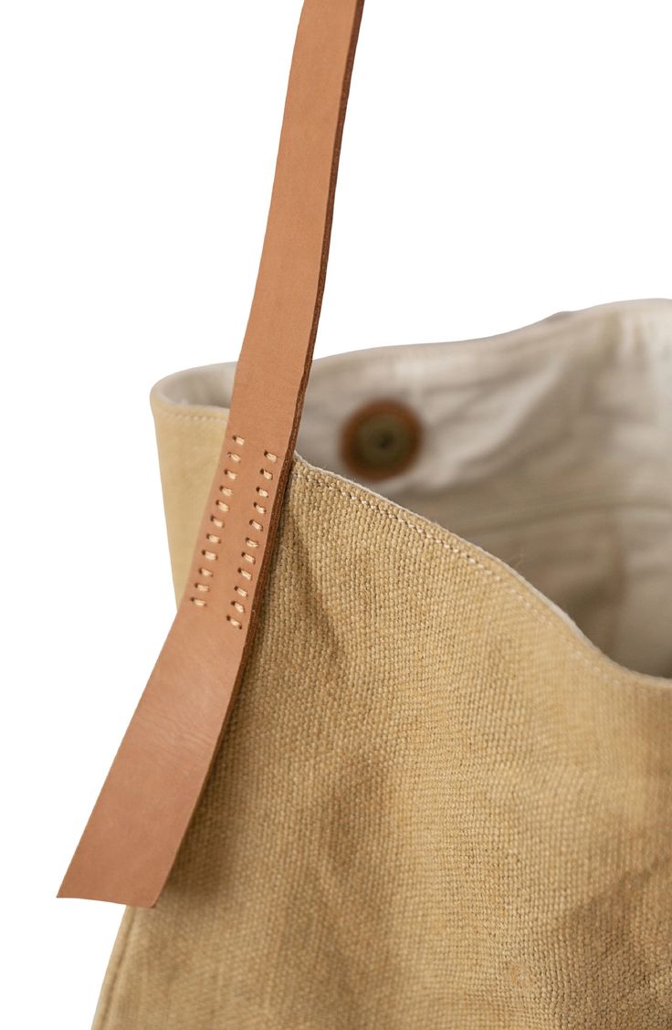 This incredibly roomy shoulder tote is crafted by artisans in Bangladesh, detailed by a row of stitches down the front and flaps of leather at the sides. The handmade jute-canvas bag meets Fair Trade standards, ensuring ethical process from start to finish. Style Name:Will & Atlas Archer Jute Tote. Style Number: 6254589. Brown Canvas Hobo Bag With Leather Trim, Light Brown Leather-handled Bucket Tote Bag, Beige Canvas Hobo Bag With Leather Trim, Brown Linen Bag For Everyday Use, Light Brown Leather Handles Bucket Bag, Light Brown Bucket Bag With Leather Handles, Light Brown Leather Handle Bucket Bag, Casual Brown Linen Bag, Brown Rectangular Bucket Bag With Canvas Lining