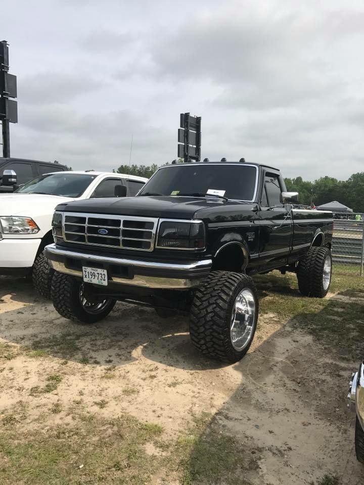 two pickup trucks parked next to each other