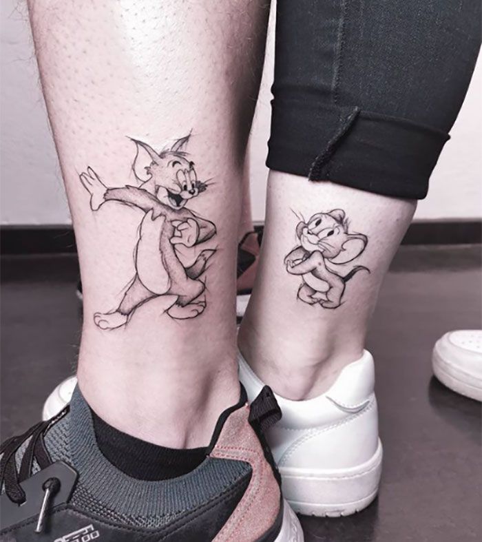 two people with matching tattoos on their legs