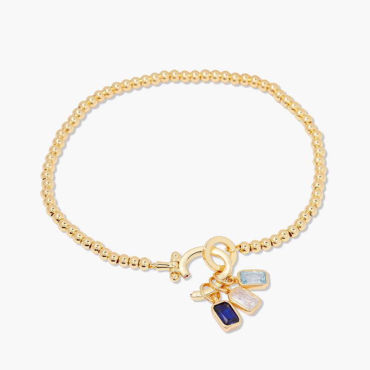 Treat yourself and your loved ones to the Mackenzie Three Birthstone Bracelet. This dazzling piece is crafted with beautiful birthstone beads, surrounded by shining gold accents. Perfect for adding a unique and stylish touch to any wardrobe, this bracelet is sure to make a statement. Rock the Mackenzie and show off your style. Avery Bracelet: Size: Available in 14k gold plated brass, 6" bead bracelet, hinge closure measures 1/2", 4mm beads Mackenzie Birthstone Charm: Available in 14k gold plated Elegant Gold Beaded Bracelets With Gemstone Accents, Elegant Gold Crystal Bracelet With Birthstone, Elegant Gold Crystal Birthstone Bracelet, Gold Crystal Bracelet With Birthstone, Adjustable Gold Beaded Bracelets With Gemstone Accents, Gold Beaded Bracelets With Gemstone Accents, Gold Beaded Bracelets With Stones, Elegant Gold Charm Bracelet With Birthstone, Elegant Gold Charm Bracelet With Faceted Beads