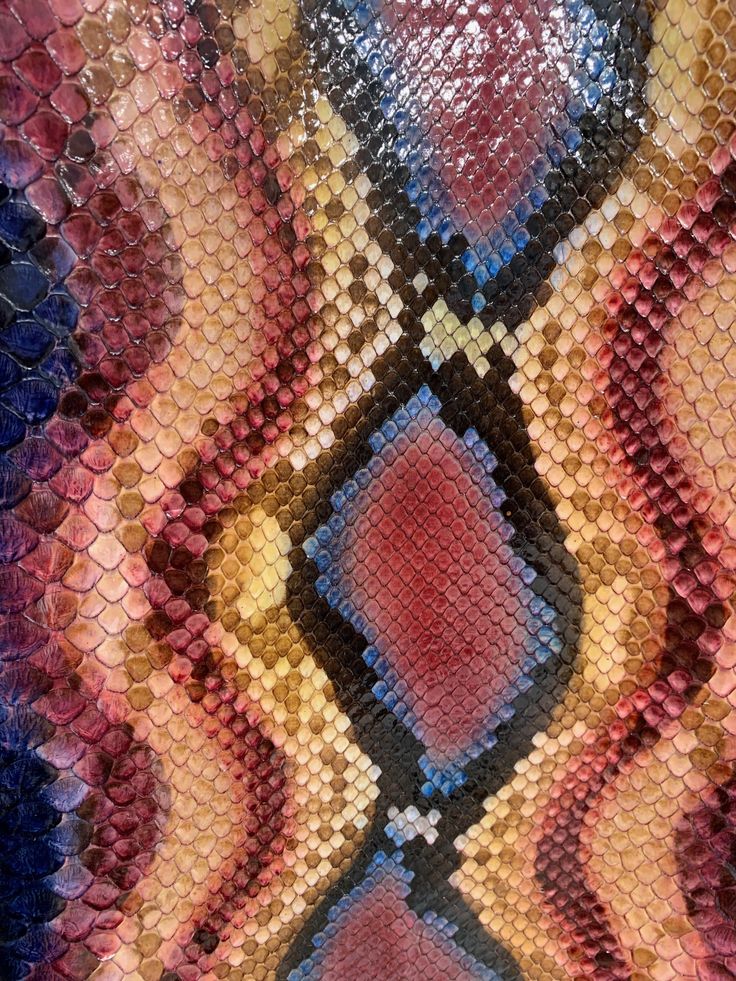 an abstract pattern made up of snakeskinned fabric and sequins on the surface