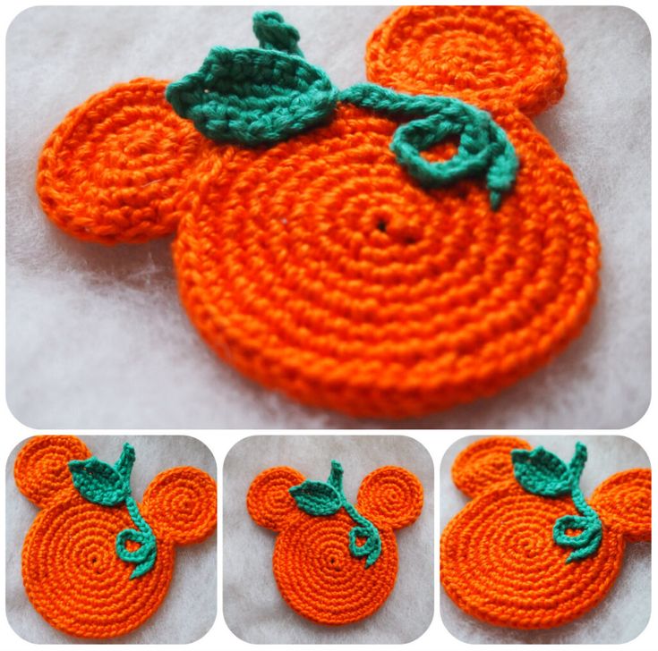 an orange crocheted coaster with green leaves on it